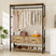A wooden and metal freestanding closet organizer with hanging rods, shoe racks, and storage drawers, blending rustic and industrial styles.