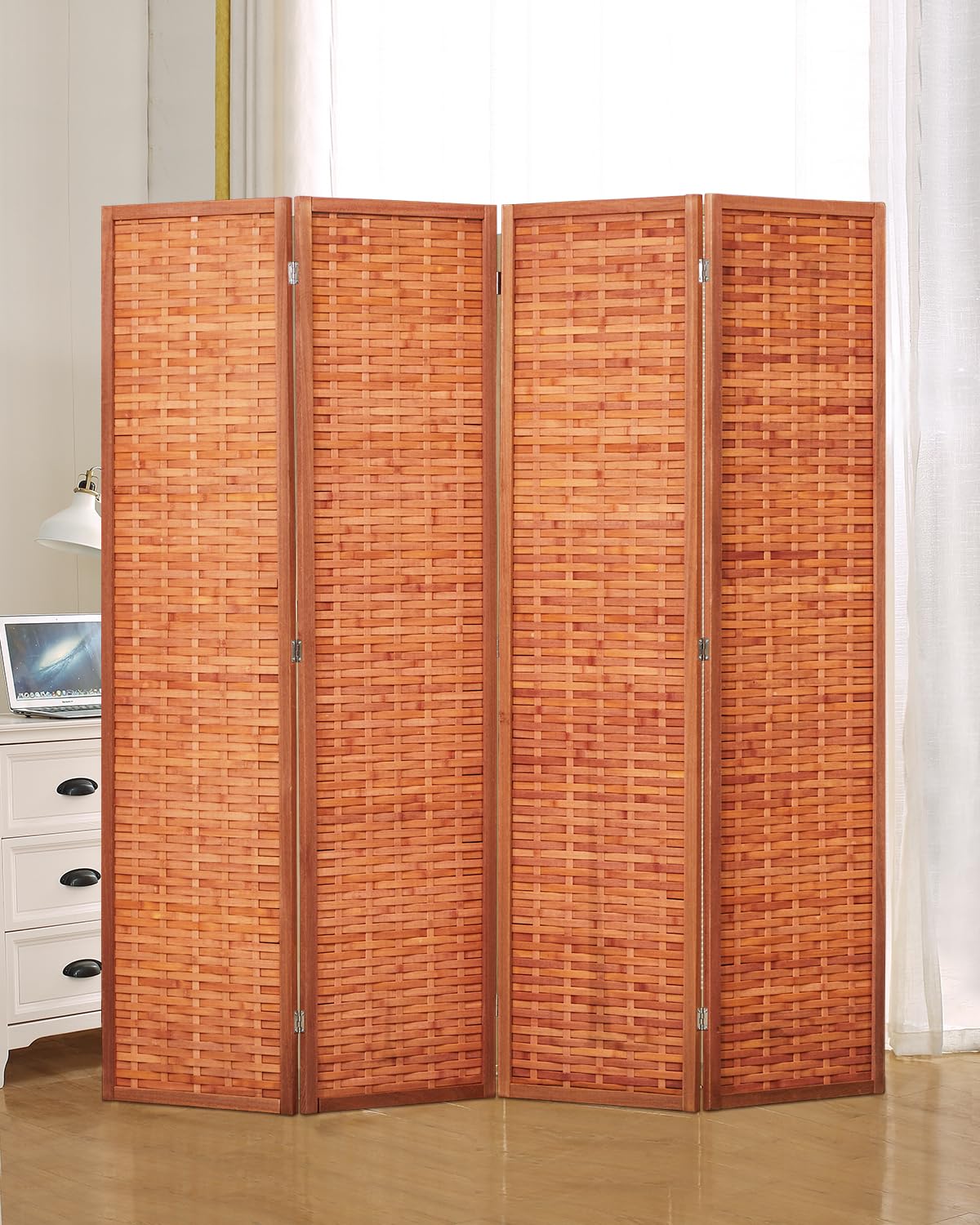 4-panel saddle brown room divider made of wood and bamboo, displayed in a cozy bedroom setting next to a white dresser and lamp, providing functional privacy.