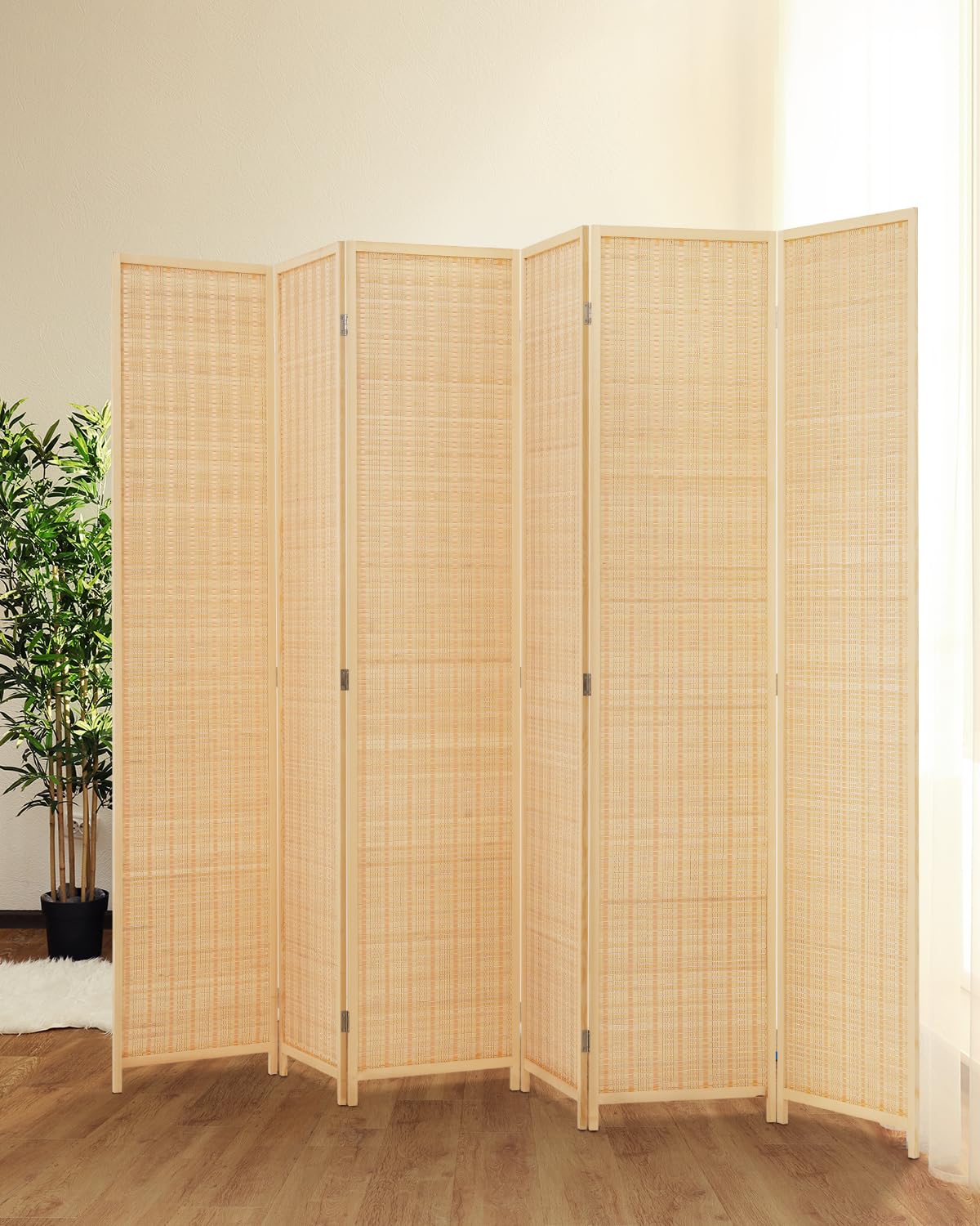 6-panel beige room divider displayed in a sunlit living room with a natural bamboo weave, offering a light and minimalist touch to the decor.