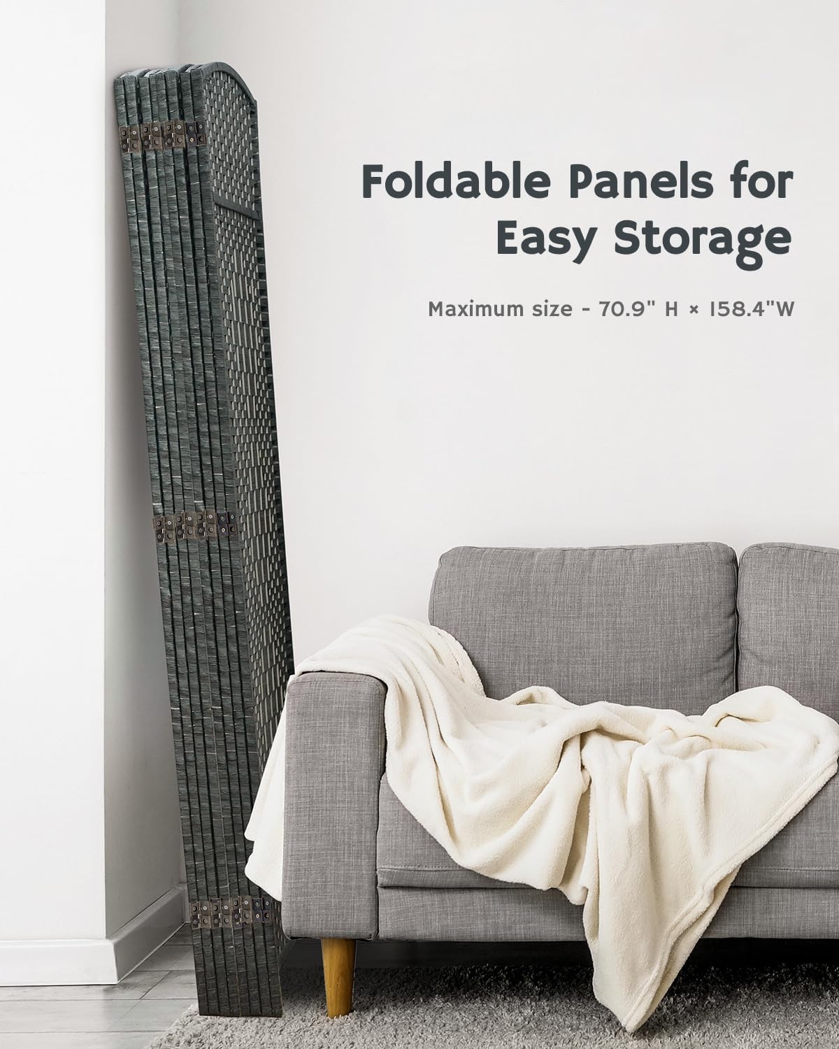 Compact folded grey bamboo room divider stored beside a gray armchair, showcasing its practical, space-saving design for modern interiors.