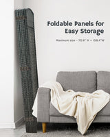 Compact folded grey bamboo room divider stored beside a gray armchair, showcasing its practical, space-saving design for modern interiors.