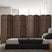 An 8-panel dark brown bamboo room divider with a woven design stands behind a modern bed, blending style and privacy in a bright, minimalistic bedroom.