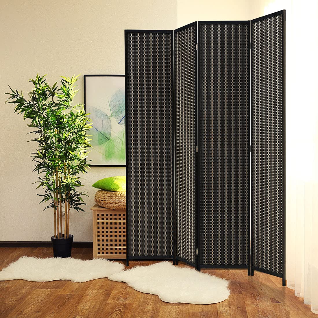 4-panel black room divider made of wood and bamboo, displayed in a cozy living room corner with a potted plant and artwork, offering privacy and modern aesthetics.