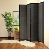 4-panel black room divider made of wood and bamboo, displayed in a cozy living room corner with a potted plant and artwork, offering privacy and modern aesthetics.