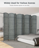 Grey bamboo 8-panel divider behind a white sofa in a bright living room, creating versatile space separation with a contemporary, natural design.