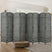 A sleek 8-panel grey bamboo room divider with a woven design stands behind a modern bed, offering privacy and style in a bright, minimalistic bedroom.