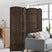 4-panel brown room divider displayed in a modern living room setting, positioned behind a gray sofa to create a stylish and functional private space.